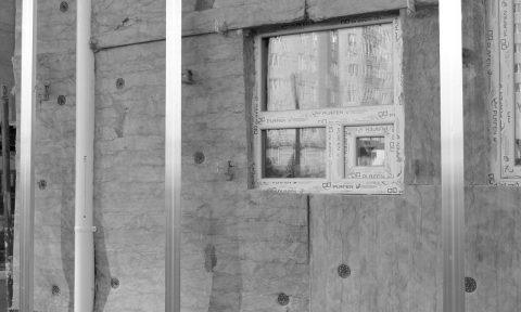 A window in the wall of an unfinished building.