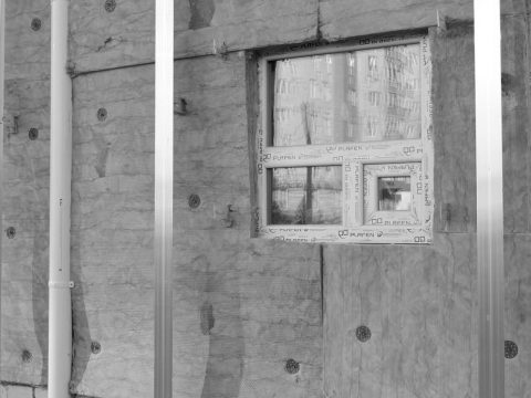 A window in the wall of an unfinished building.