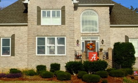 A brick house with a wreath on the front of it.