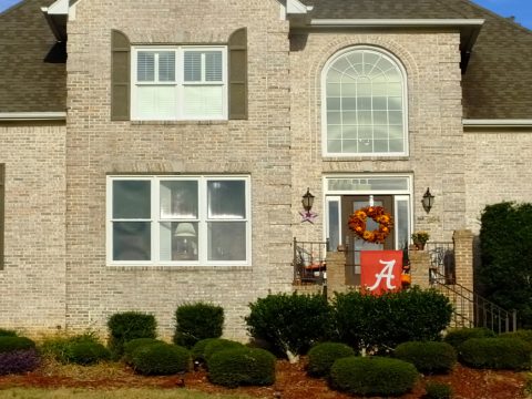 A brick house with a wreath on the front of it.